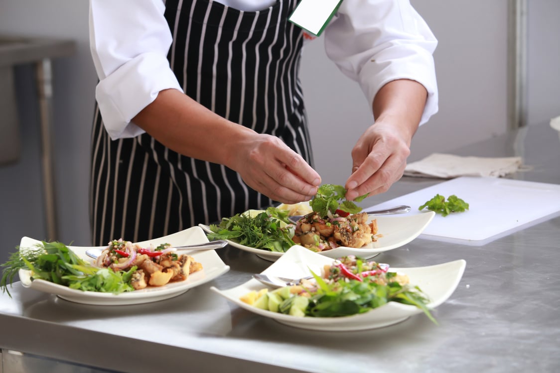 Chef in restaurant kitchen cooking